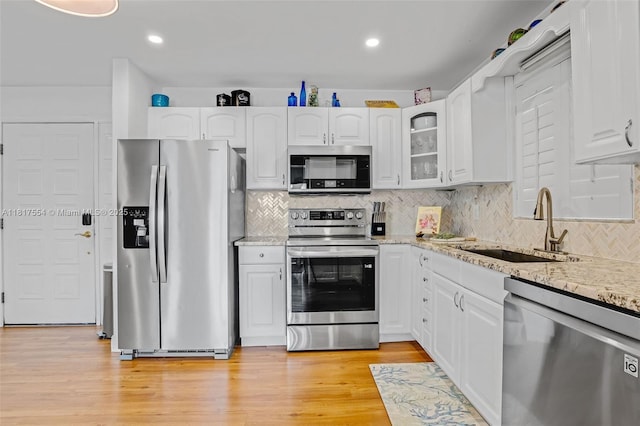 200 Wrenn St Ph 701, Plantation Key, FL 33070 - kitchen featuring appliances with stainless steel finishes, a sink, white cabinets, light stone counters, and backsplash