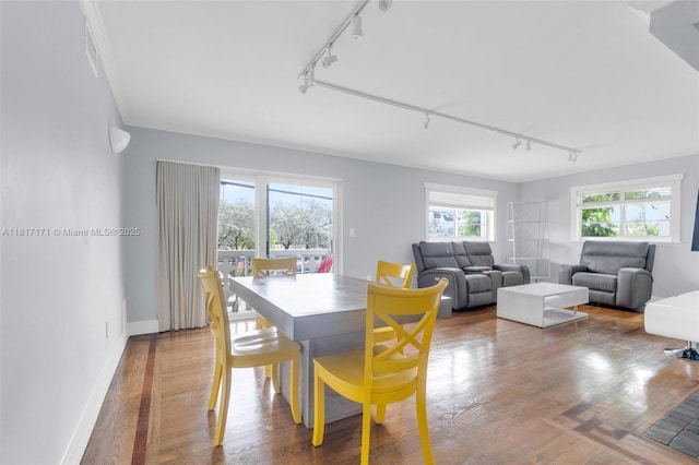 1100 11th St Unit 208, Miami Beach, FL 33139 - dining room with rail lighting, wood finished floors, and baseboards