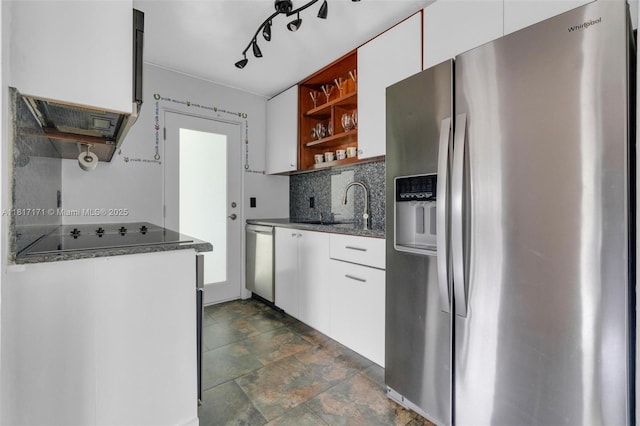 1100 11th St Unit 208, Miami Beach, FL 33139 - kitchen featuring stainless steel appliances, open shelves, tasteful backsplash, white cabinetry, and stone finish flooring