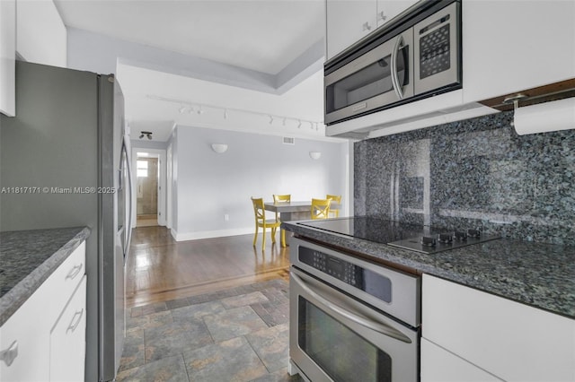 1100 11th St Unit 208, Miami Beach, FL 33139 - kitchen featuring appliances with stainless steel finishes, white cabinetry, tasteful backsplash, baseboards, and dark wood-style floors