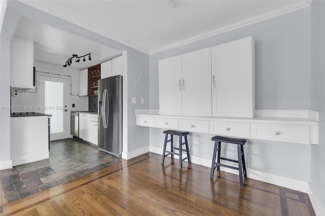 1100 11th St Unit 208, Miami Beach, FL 33139 - kitchen with stainless steel appliances, ornamental molding, white cabinets, baseboards, and dark wood-style flooring