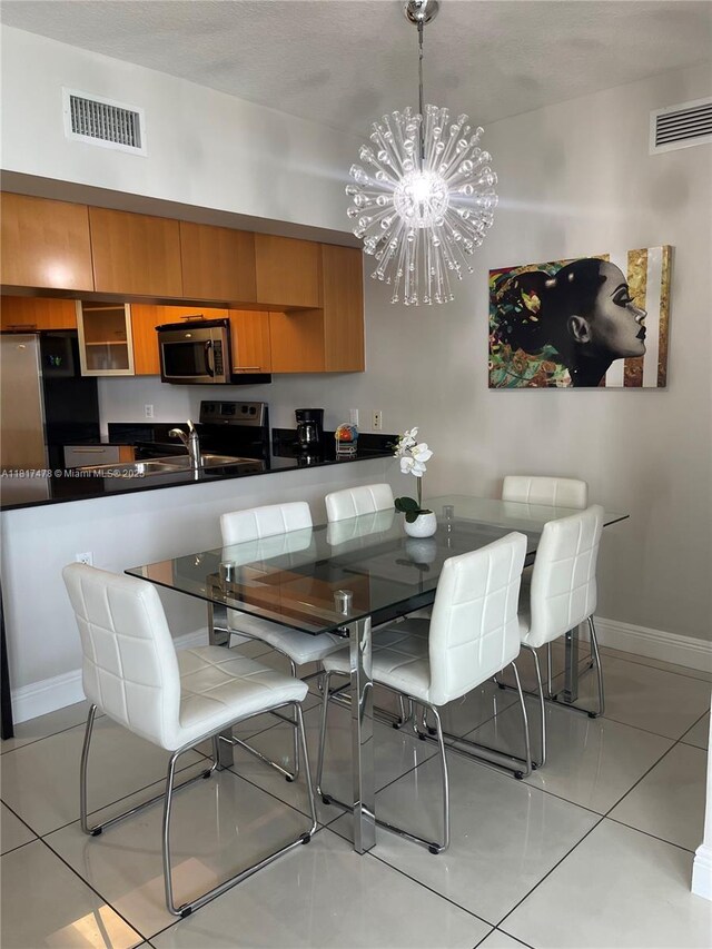 1750 N Bayshore Dr Unit 1414, Miami, FL 33132 - dining space featuring a chandelier, baseboards, and light tile patterned floors