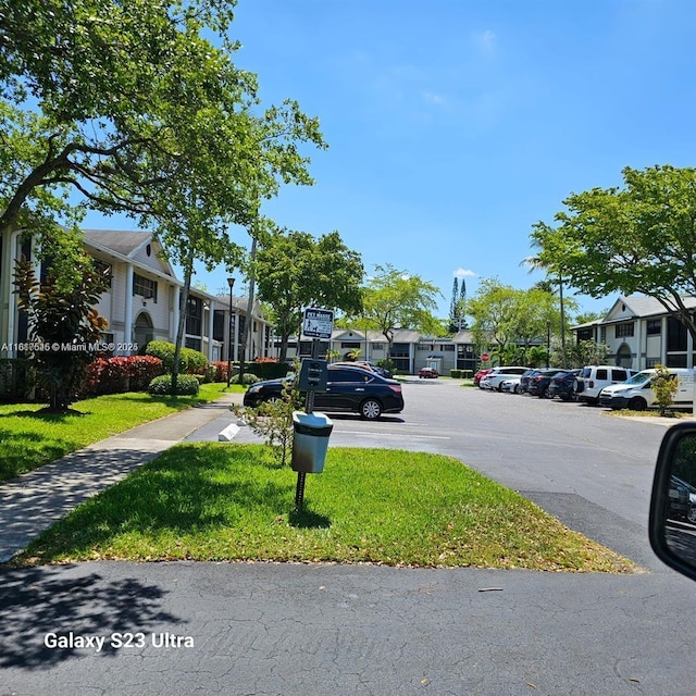 927 NE 199th St Unit 205, Miami, FL 33179 - view of asphalt street featuring a residential view and sidewalks