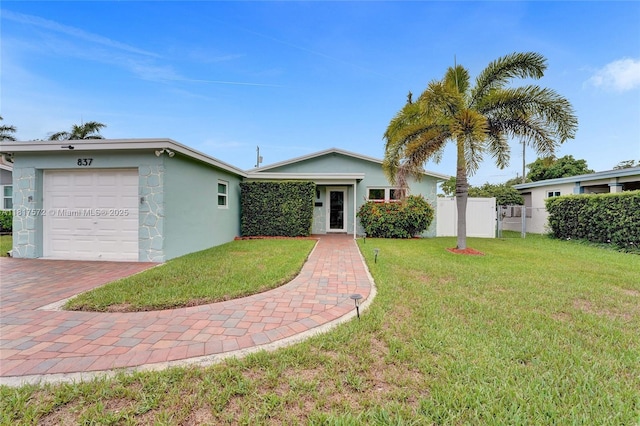 837 NW 10th Ave, Dania Beach, FL 33004 - single story home with a garage, stucco siding, and decorative driveway