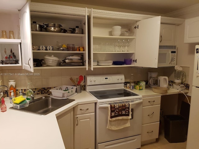 3740 Inverrary Dr Unit 3D, Lauderhill, FL 33319 - kitchen with white appliances, backsplash, open shelves, light countertops, and ornamental molding