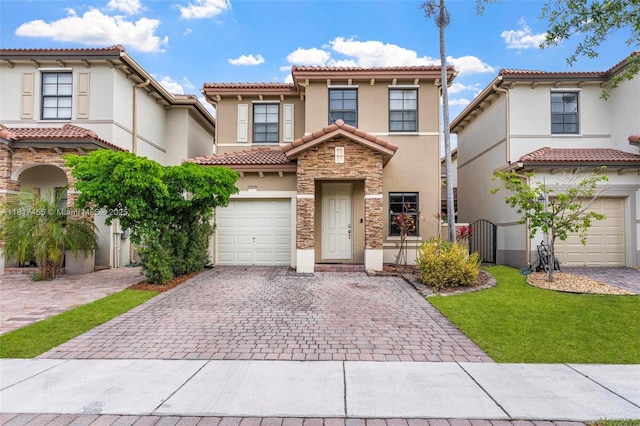 22791 SW 88th Pl, Cutler Bay, FL 33190 - mediterranean / spanish-style house featuring decorative driveway, stucco siding, a tiled roof, stone siding, and a garage