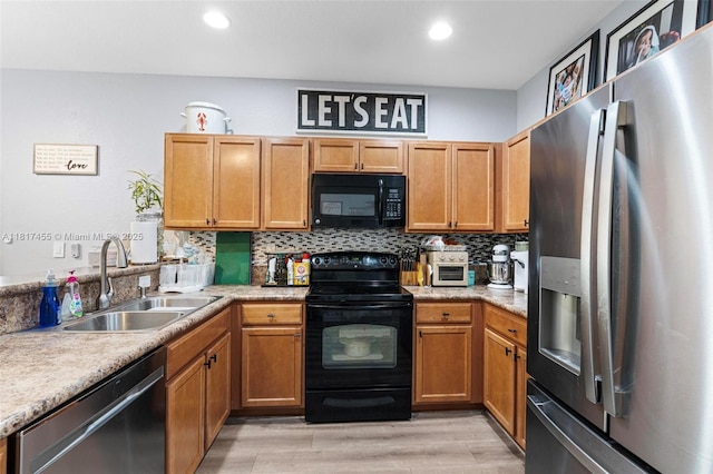 22791 SW 88th Pl, Cutler Bay, FL 33190 - kitchen featuring black appliances, a sink, light countertops, tasteful backsplash, and light wood finished floors