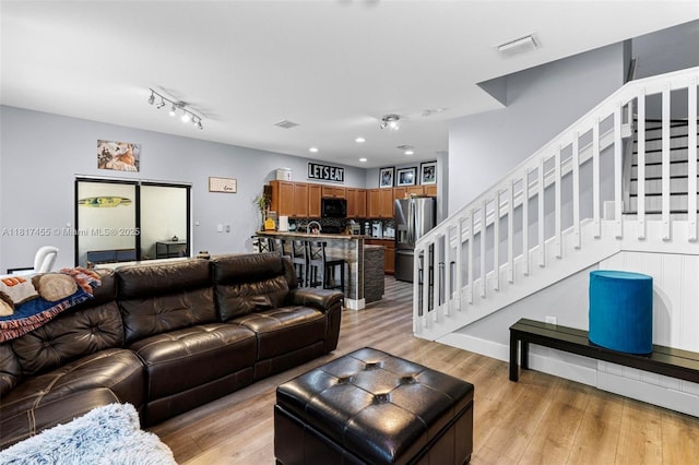 22791 SW 88th Pl, Cutler Bay, FL 33190 - living room with stairs and light wood-style floors