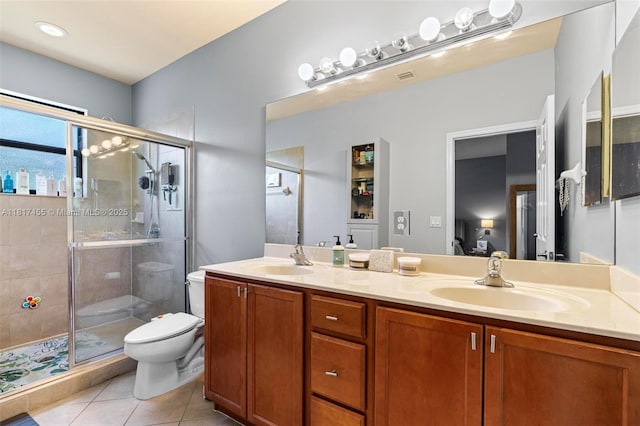 22791 SW 88th Pl, Cutler Bay, FL 33190 - bathroom featuring toilet, double vanity, tile patterned floors, and a stall shower