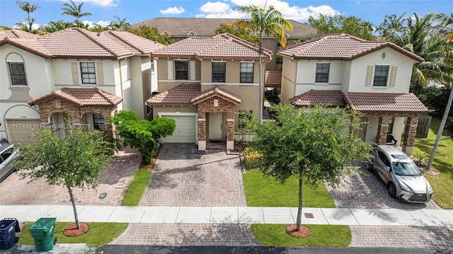22791 SW 88th Pl, Cutler Bay, FL 33190 - mediterranean / spanish house featuring decorative driveway, a tile roof, stucco siding, stone siding, and a residential view