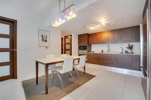 485 Brickell Ave Unit 1801, Miami, FL 33131 - kitchen featuring stainless steel appliances, light countertops, hanging light fixtures, light tile patterned floors, and modern cabinets