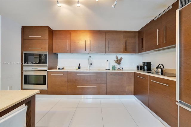 485 Brickell Ave Unit 1801, Miami, FL 33131 - kitchen featuring black appliances, light countertops, tile patterned flooring, and modern cabinets