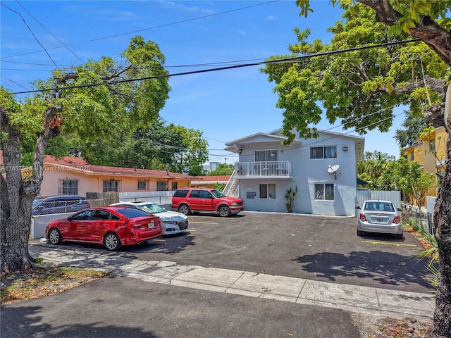 1621 NW 16th St, Miami, FL 33125 - view of front of house with uncovered parking, stucco siding, and a balcony