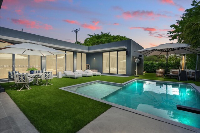 1845 NE 124th St, North Miami, FL 33181 - outdoor pool featuring outdoor lounge area, a lawn, and a patio