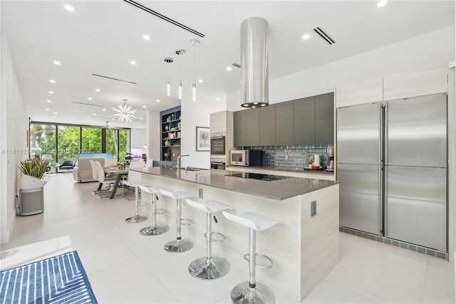 1845 NE 124th St, North Miami, FL 33181 - kitchen featuring stainless steel appliances, modern cabinets, a sink, tasteful backsplash, and recessed lighting