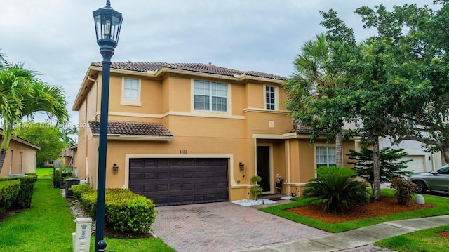 4452 Rainbow Ave, Weston, FL 33332 - townhome / multi-family property with a tile roof, an attached garage, stucco siding, and decorative driveway