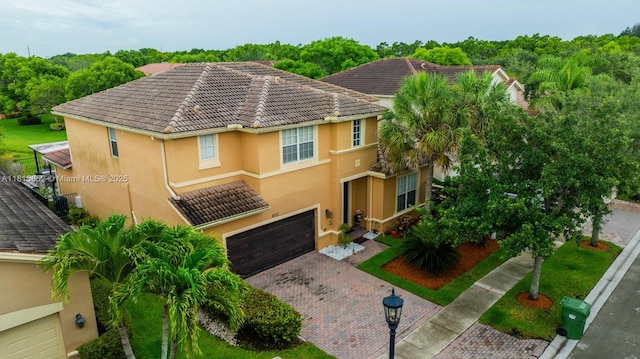 4452 Rainbow Ave, Weston, FL 33332 - view of front of home featuring stucco siding, a garage, decorative driveway, and a tile roof