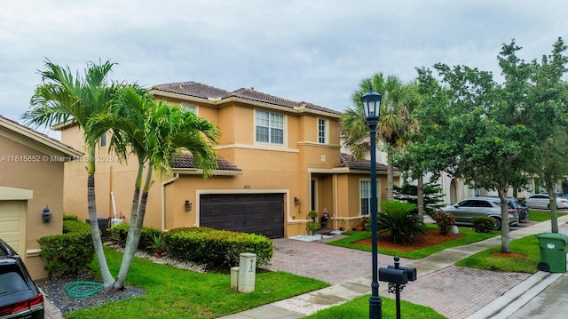 4452 Rainbow Ave, Weston, FL 33332 - multi unit property featuring an attached garage, decorative driveway, a tiled roof, stucco siding, and a front lawn