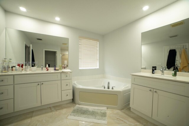 4452 Rainbow Ave, Weston, FL 33332 - bathroom featuring marble finish floors, a bath, two vanities, and recessed lighting