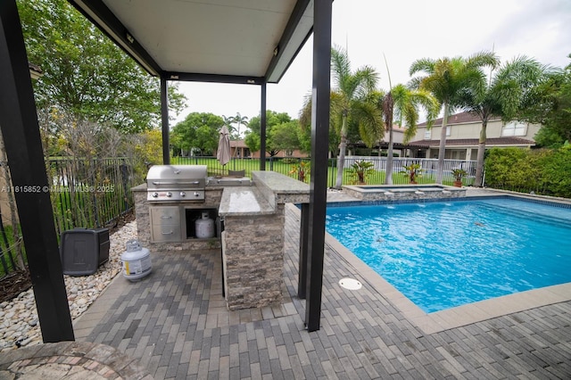 4452 Rainbow Ave, Weston, FL 33332 - view of swimming pool featuring an outdoor kitchen, a fenced backyard, a pool with connected hot tub, and a patio area