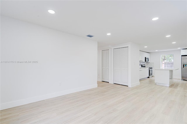 6044 SW 37th St, Miramar, FL 33023 - unfurnished living room with light wood finished floors, baseboards, and recessed lighting