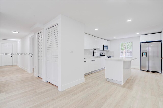 6044 SW 37th St, Miramar, FL 33023 - kitchen with stainless steel appliances, modern cabinets, light wood finished floors, light countertops, and white cabinetry