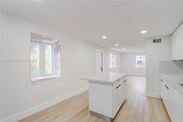 6044 SW 37th St, Miramar, FL 33023 - kitchen featuring white cabinetry, a kitchen island, light wood finished floors, baseboards, and recessed lighting