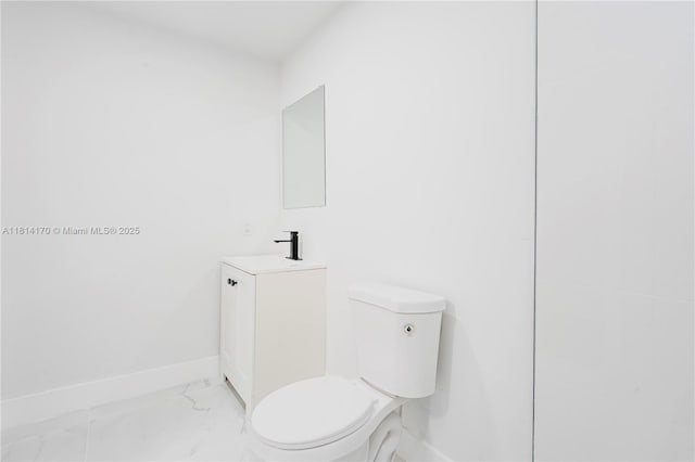 6044 SW 37th St, Miramar, FL 33023 - bathroom featuring vanity, toilet, marble finish floors, and baseboards