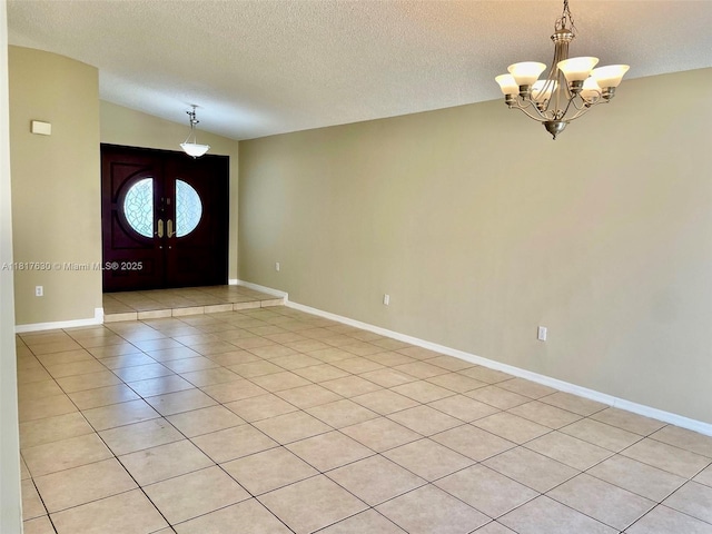 14610 SW 170th Ter, Miami, FL 33177 - entrance foyer with a chandelier, a textured ceiling, light tile patterned flooring, baseboards, and lofted ceiling