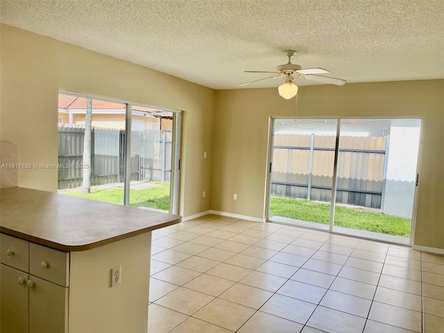 14610 SW 170th Ter, Miami, FL 33177 - empty room with a ceiling fan, light tile patterned floors, a textured ceiling, and baseboards