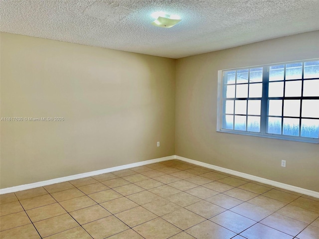 14610 SW 170th Ter, Miami, FL 33177 - spare room with a textured ceiling, baseboards, and light tile patterned floors