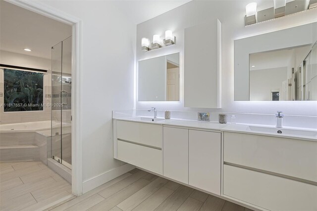 4425 NW 93rd Doral Ct, Doral, FL 33178 - full bath with a garden tub, double vanity, a stall shower, baseboards, and wood finish floors