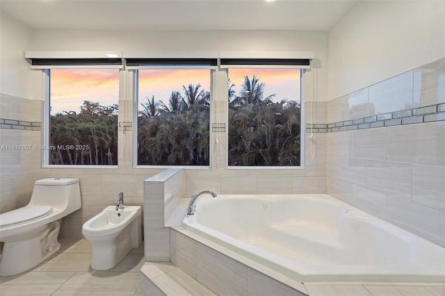 4425 NW 93rd Doral Ct, Doral, FL 33178 - bathroom with a bath, toilet, tile walls, and a bidet