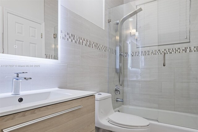 4425 NW 93rd Doral Ct, Doral, FL 33178 - bathroom with toilet, vanity, tile walls, and combined bath / shower with glass door