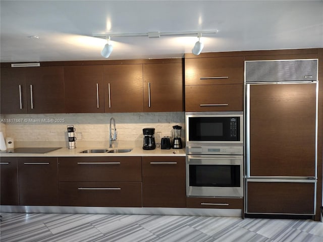 485 Brickell Ave Unit 4711, Miami, FL 33131 - kitchen with built in appliances, a sink, modern cabinets, and light countertops