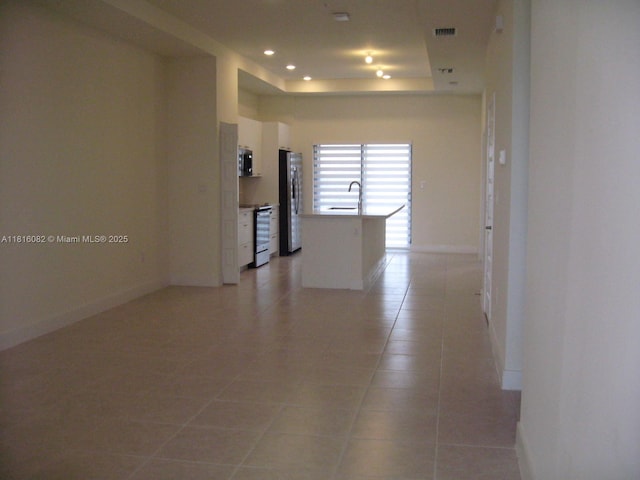 8055 NW 104th Ave Unit 32, Doral, FL 33178 - unfurnished room with a sink, light tile patterned flooring, baseboards, a tray ceiling, and recessed lighting