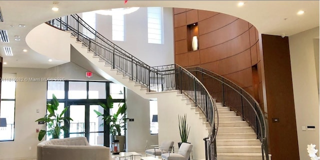 8055 NW 104th Ave Unit 32, Doral, FL 33178 - stairs featuring a towering ceiling, healthy amount of natural light, recessed lighting, baseboards, and french doors