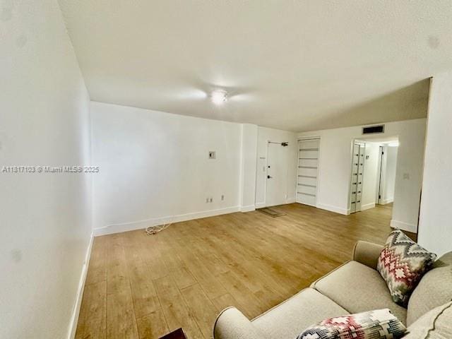 110 Salamanca Ave Unit 207, Coral Gables, FL 33134 - living area featuring light wood-style flooring and baseboards