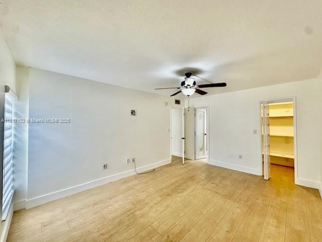 110 Salamanca Ave Unit 207, Coral Gables, FL 33134 - unfurnished bedroom featuring light wood-style floors, a walk in closet, and ceiling fan