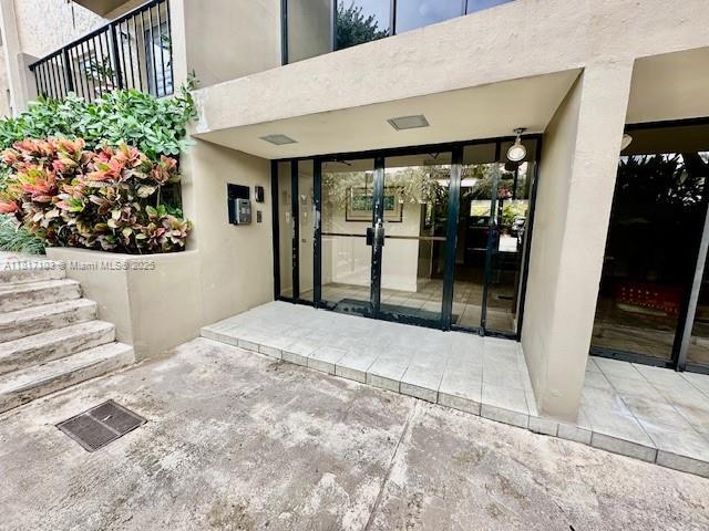110 Salamanca Ave Unit 207, Coral Gables, FL 33134 - entrance to property featuring stucco siding and a balcony