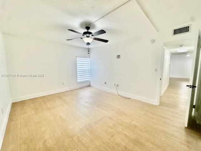 110 Salamanca Ave Unit 207, Coral Gables, FL 33134 - spare room with light wood finished floors and ceiling fan