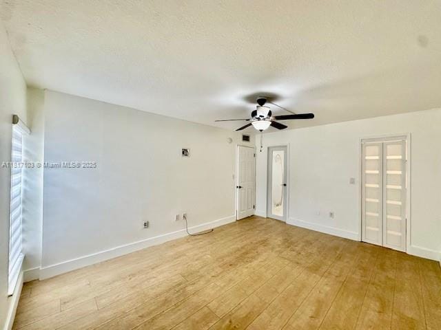 110 Salamanca Ave Unit 207, Coral Gables, FL 33134 - unfurnished room featuring light wood-style flooring, a ceiling fan, and baseboards