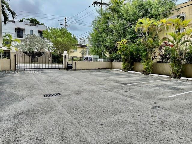 110 Salamanca Ave Unit 207, Coral Gables, FL 33134 - uncovered parking lot featuring a gate
