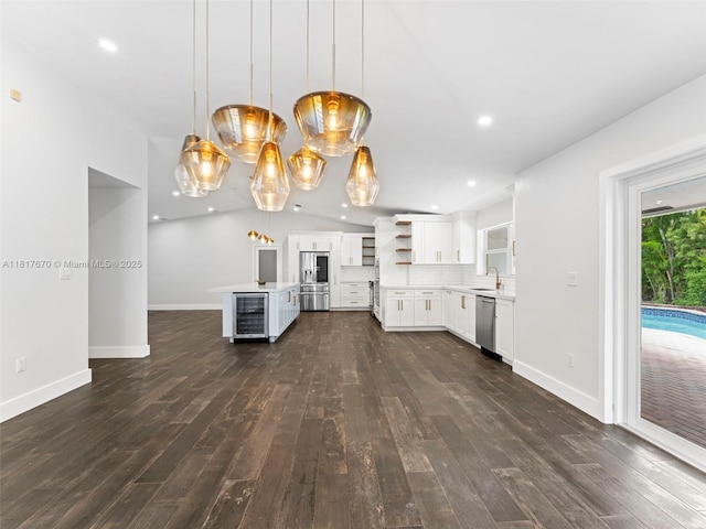 5976 SW 88th Pl, Miami, FL 33173 - kitchen with beverage cooler, appliances with stainless steel finishes, open shelves, light countertops, and recessed lighting
