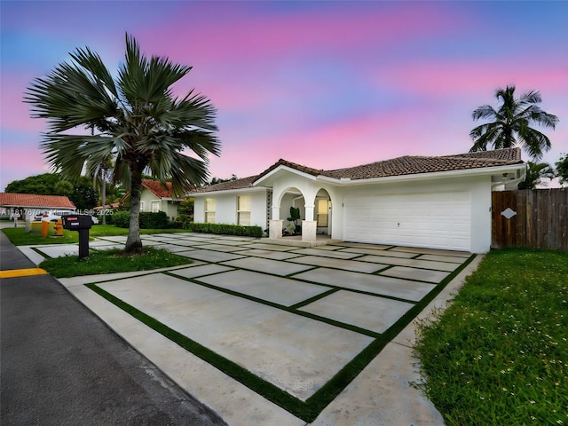 5976 SW 88th Pl, Miami, FL 33173 - view of front facade with stucco siding, concrete driveway, an attached garage, and a tiled roof