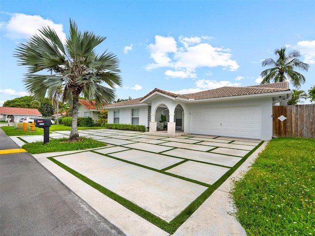 5976 SW 88th Pl, Miami, FL 33173 - view of front of home with stucco siding, an attached garage, concrete driveway, and a tiled roof