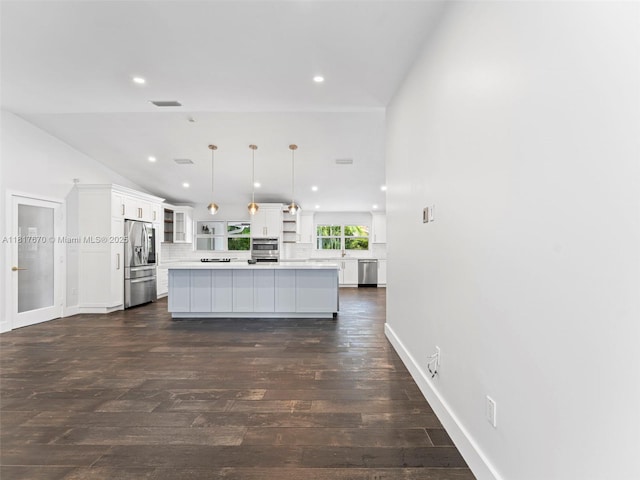 5976 SW 88th Pl, Miami, FL 33173 - kitchen with stainless steel appliances, backsplash, white cabinetry, open shelves, and light countertops