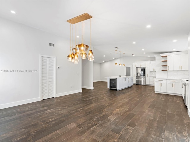 5976 SW 88th Pl, Miami, FL 33173 - unfurnished living room featuring beverage cooler, dark wood-type flooring, a chandelier, and recessed lighting