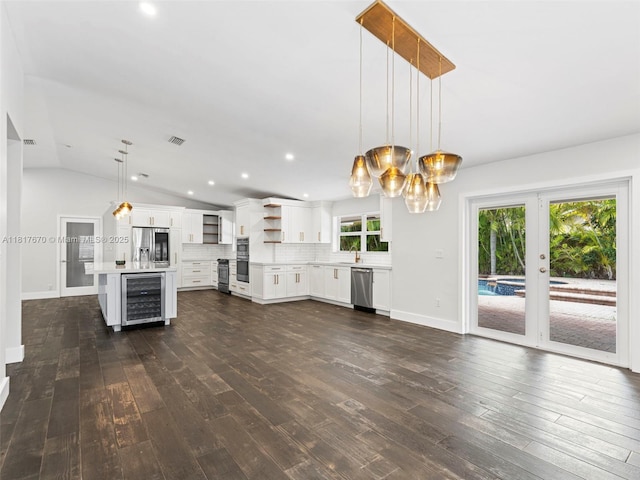 5976 SW 88th Pl, Miami, FL 33173 - unfurnished living room featuring wine cooler, dark wood-style flooring, french doors, lofted ceiling, and a chandelier
