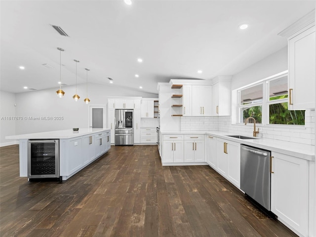 5976 SW 88th Pl, Miami, FL 33173 - kitchen with beverage cooler, stainless steel appliances, open shelves, dark wood-type flooring, and vaulted ceiling
